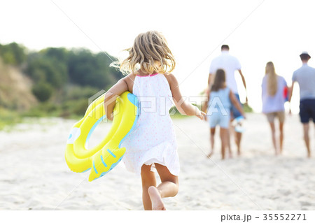 Young blonde girl running on the beech Young blonde girl running on the beech 35552271