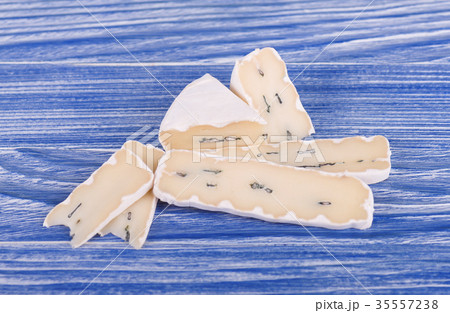 Blue cheese on blue wooden background 35557238