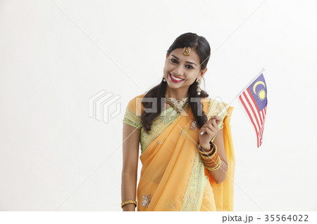 Indian woman in traditional clothing holding flag Indian woman in traditional clothing holding flag 35564022
