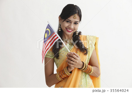 Indian woman in traditional clothing holding flag 35564024