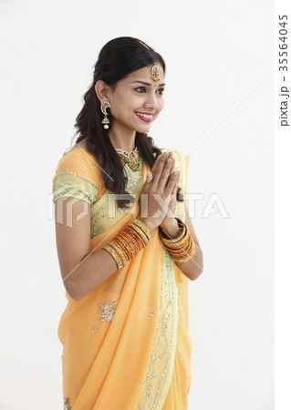 Indian woman in traditional clothing greeting Indian woman in traditional clothing greeting 35564045