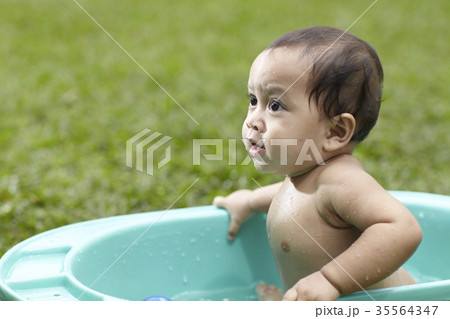 baby taking bath outdoor 35564347