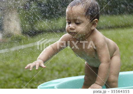 baby taking bath outdoor 35564355