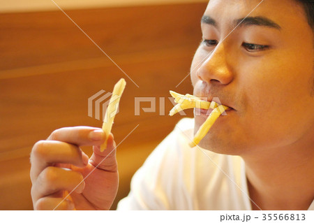 man eating french fries, fried fast food man eating french fries, fried fast food 35566813