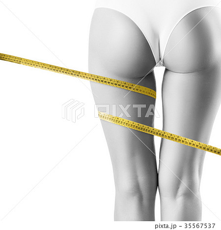 Female legs with measuring tape. Female legs with measuring tape. 35567537