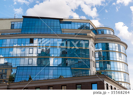 Beautiful Glass office building on sky background Beautiful Glass office building on sky background 35568264