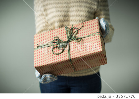 A girl holding a box with a Christmas present A girl holding a box with a Christmas present 35571776