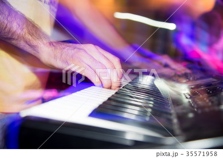 Musician plays keyboards in a rock band 35571958