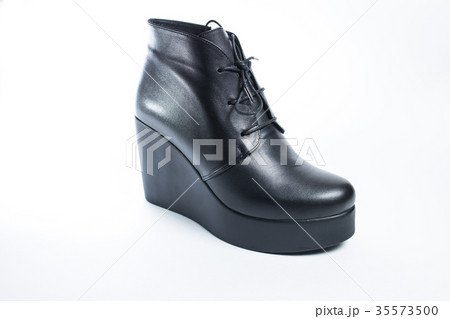 Female black boots isolated on a white background. Female black boots isolated on a white background. 35573500