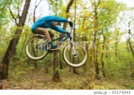 a young guy in a helmet flies landed on a bicycle a young guy in a helmet flies landed on a bicycle 35574043