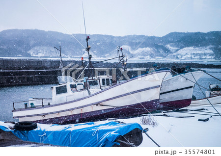 Japanese fishing boat on beach with snow fall Japanese fishing boat on beach with snow fall 35574801