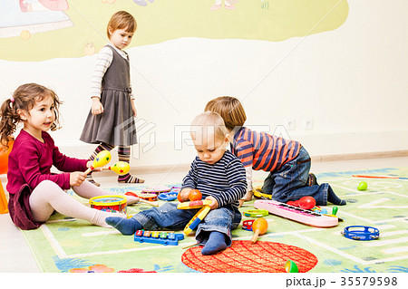 Three kids playing with toys 35579598