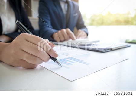 Business team two executive colleagues discussing and analysis w 35581601