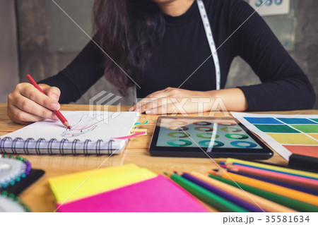 Young woman dressmaker or designer working as fashion designers 35581634