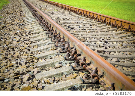 Rusty railway with grass on sides Rusty railway with grass on sides 35583170