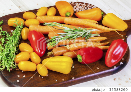 Peppers, tomatoes, carrots, thyme, basil on a tabl Peppers, tomatoes, carrots, thyme, basil on a tabl 35583260