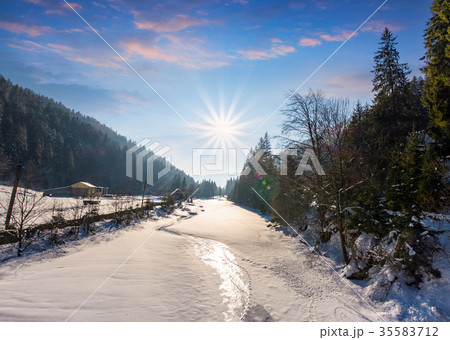 frozen river in forested mountains frozen river in forested mountains 35583712