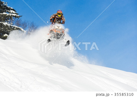 Rider on the snowmobile in the mountains ski 35585310