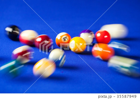 blurry and moving of billiard balls in a blue pool 35587949