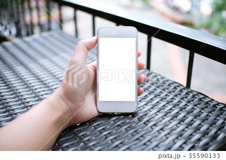 Close up of women's hands holding cell telephone 35590133
