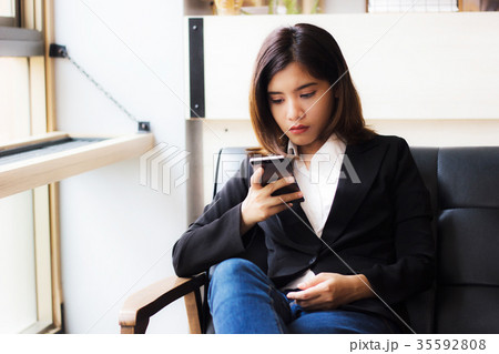 Business woman using smartphone checking e-mail 35592808