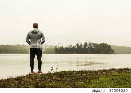 Man standing at lake of two rivers algonquin 35593089