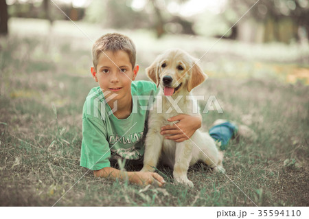 Retriever pup Lovely scene handsom teen boy Retriever pup Lovely scene handsom teen boy 35594110