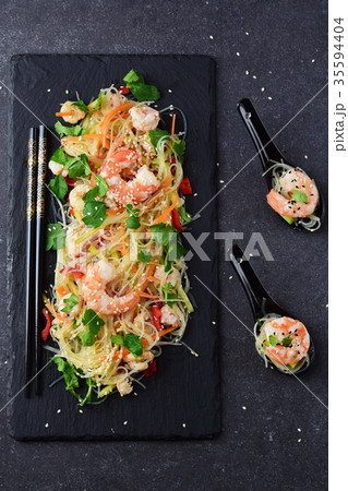 Noodles and prawns, vegetables on a black stone Noodles and prawns, vegetables on a black stone 35594404
