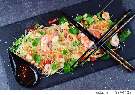 Noodles and prawns, vegetables on a black stone Noodles and prawns, vegetables on a black stone 35594405