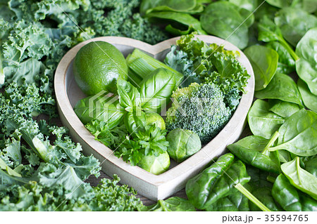 Green vegetables and herbs in heart health concept Green vegetables and herbs in heart health concept 35594765