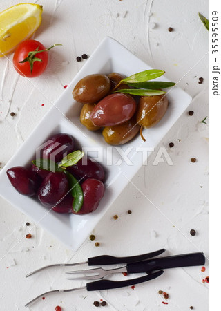 White plate with black and green olives White plate with black and green olives 35595509
