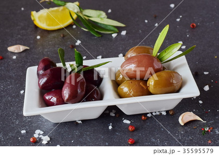 Black and green olives on a white plate Black and green olives on a white plate 35595579