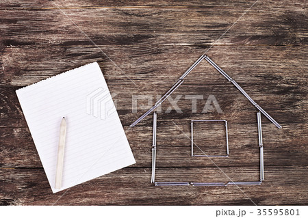 Home concept. Wooden model house on a work table Home concept. Wooden model house on a work table 35595801