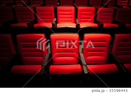 Red seat in the movie theater. Blurry background. Red seat in the movie theater. Blurry background. 35596443