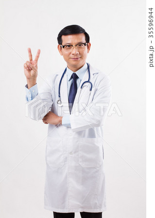 asian male doctor pointing up 2 fingers, victory asian male doctor pointing up 2 fingers, victory 35596944