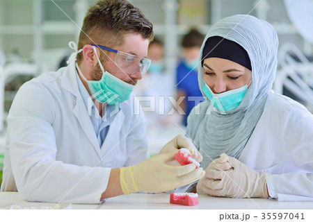 Arab students with hijab while working on the Arab students with hijab while working on the 35597041