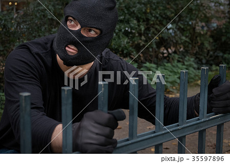 Sinister masked man skulking in the night Sinister masked man skulking in the night 35597896