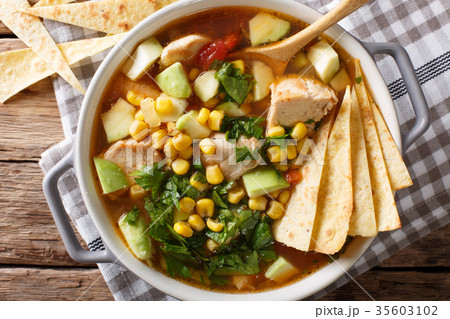 spicy tortilla soup with chicken, cilantro, tomato 35603102