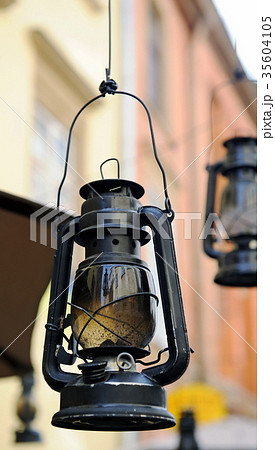 Kerosene lamp on the background of the old house 35604105