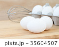 raw chicken eggs in egg box on wooden background 35604507