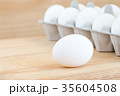 raw chicken eggs in egg box on wooden background 35604508