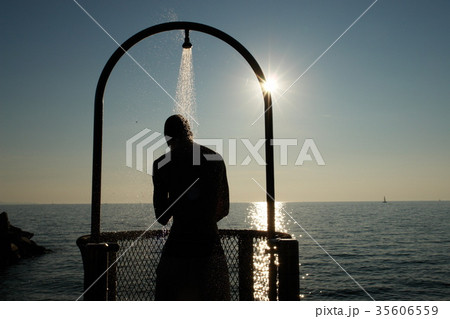 young men having fun at a shower at the beach young men having fun at a shower at the beach 35606559