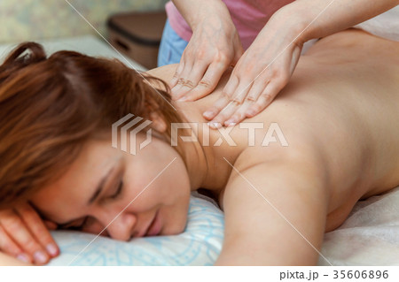 Woman doing back massage Woman doing back massage 35606896