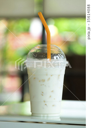 Ice Milk in Plastic cup on the cafe table. 35614088