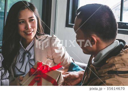 Young man is giving a present to girlfriend  35614670