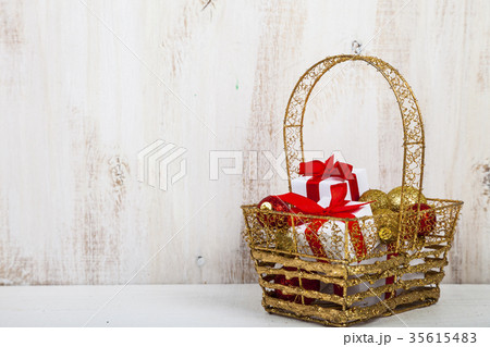 Golden basket with Christmas gifts 35615483