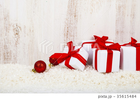 Gifts with red bows on snow Gifts with red bows on snow 35615484