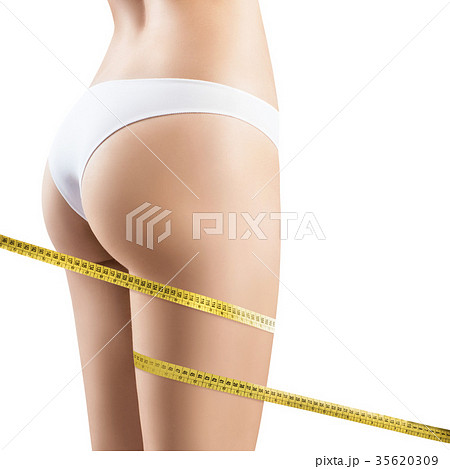 Female legs with measuring tape. Female legs with measuring tape. 35620309