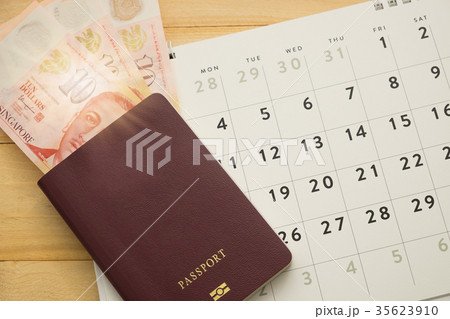top view. money in passport and calender on desk 35623910
