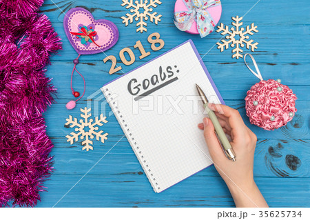 notebook with GOALS text and woman's hand holding 35625734